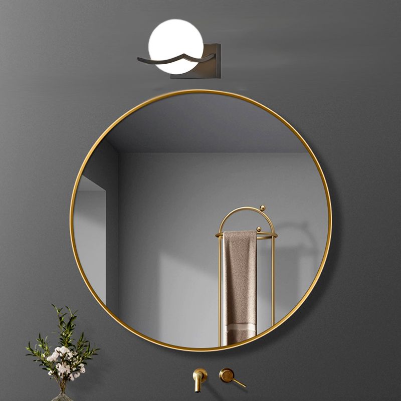 Valentina white globe above a round bathroom mirror
