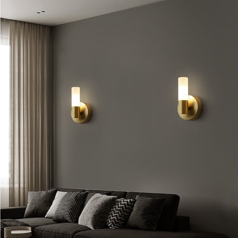 Two separate Leigh one-light sconces above a sofa