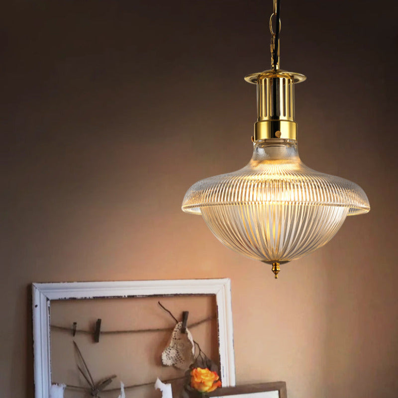 Alessio pendant illuminating ribbed glass above framed artwork.