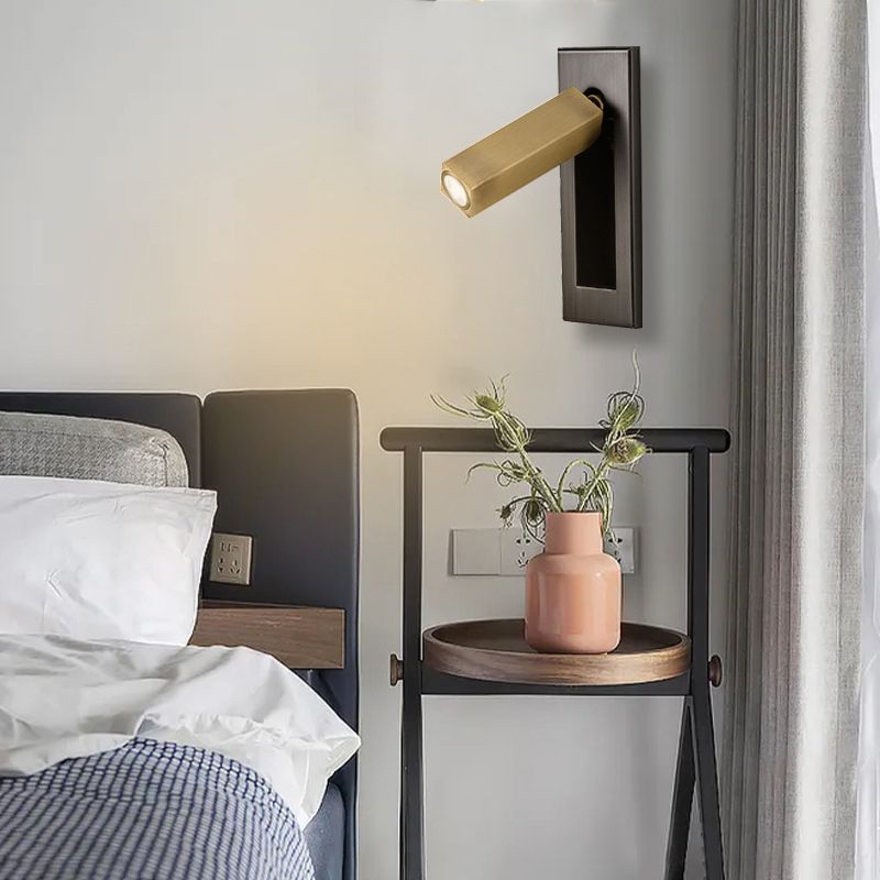 Gold Orr rectangular wall spotlight above a bedside shelf with a vase
