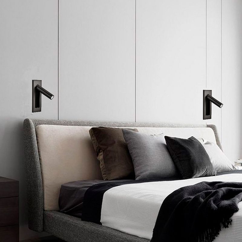 Two black Orr cylindrical wall spotlights above opposite sides of a headboard