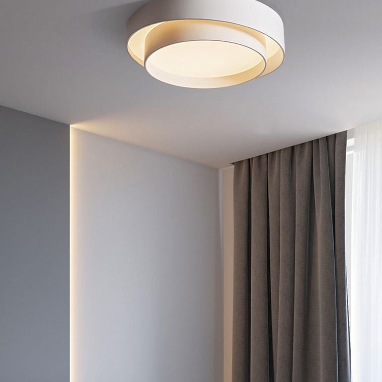 Quinn circular ceiling light beside full-height curtains in a pale room.