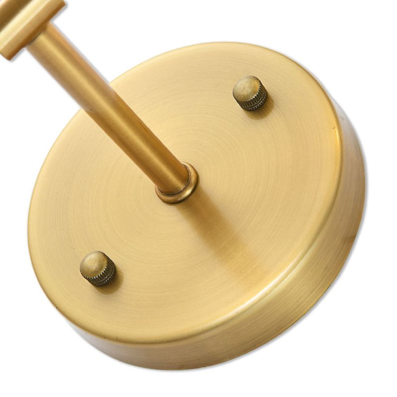 Close detail of Eryn plain gold-tone round wall plate, short arm and two cap-like details