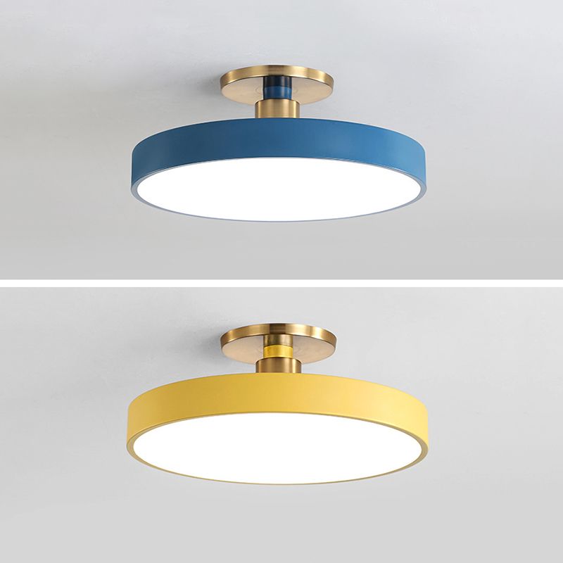 Two-panel comparison of blue and yellow round ceiling fixtures with white diffusers and gold-tone fittings