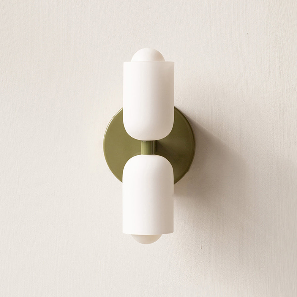 Green Morandi wall light with two white cylindrical shades and a round green backplate.