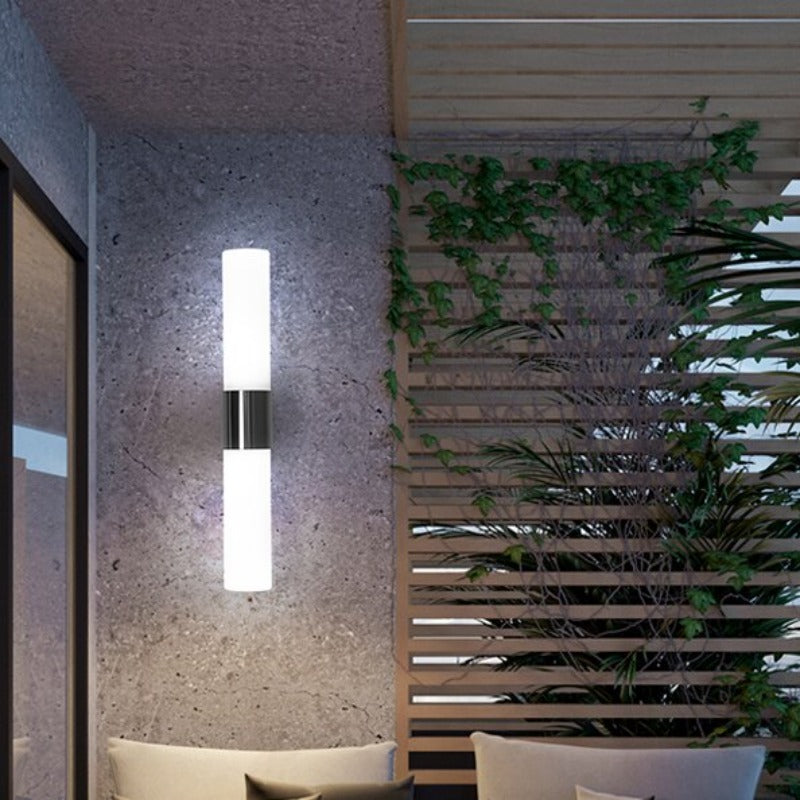 Leigh black double-ended wall light against a stone-textured wall
