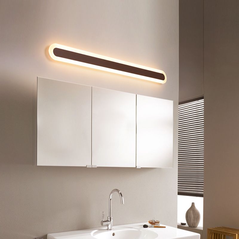 Edge Brown linear capsule light above a wide bathroom mirror