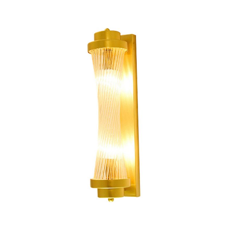 Kristy F twisted clear strands between gold-tone end rings on a narrow vertical backplate