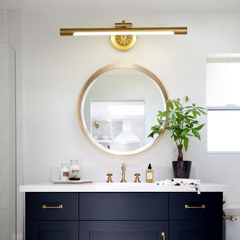 Eryn gold-colour linear light above a round bathroom mirror
