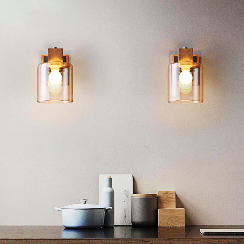 Two Eryn wall lights with glass shades below their wooden holders above a kitchen worktop