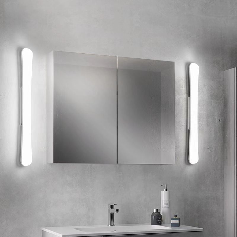 Two Edge bars placed vertically beside mirror cabinet above basin, with rear strips visible and toiletries on counter