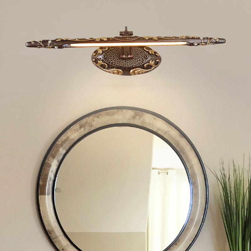 Félicie linear wall light above a round framed mirror