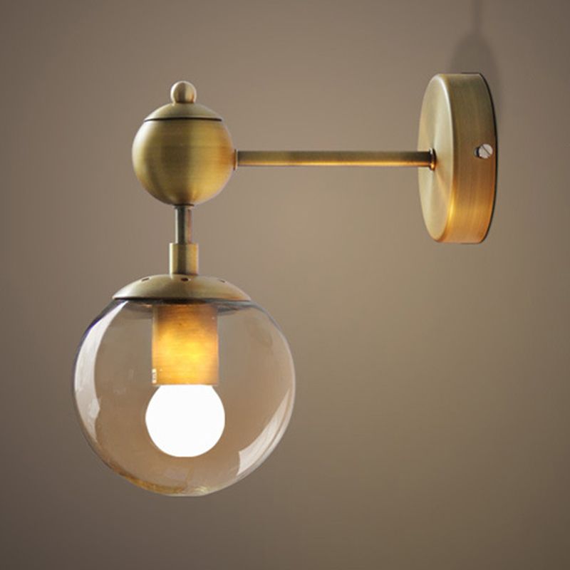 Close view of Gold Valentina single hanging glass globe, metal center and straight arm