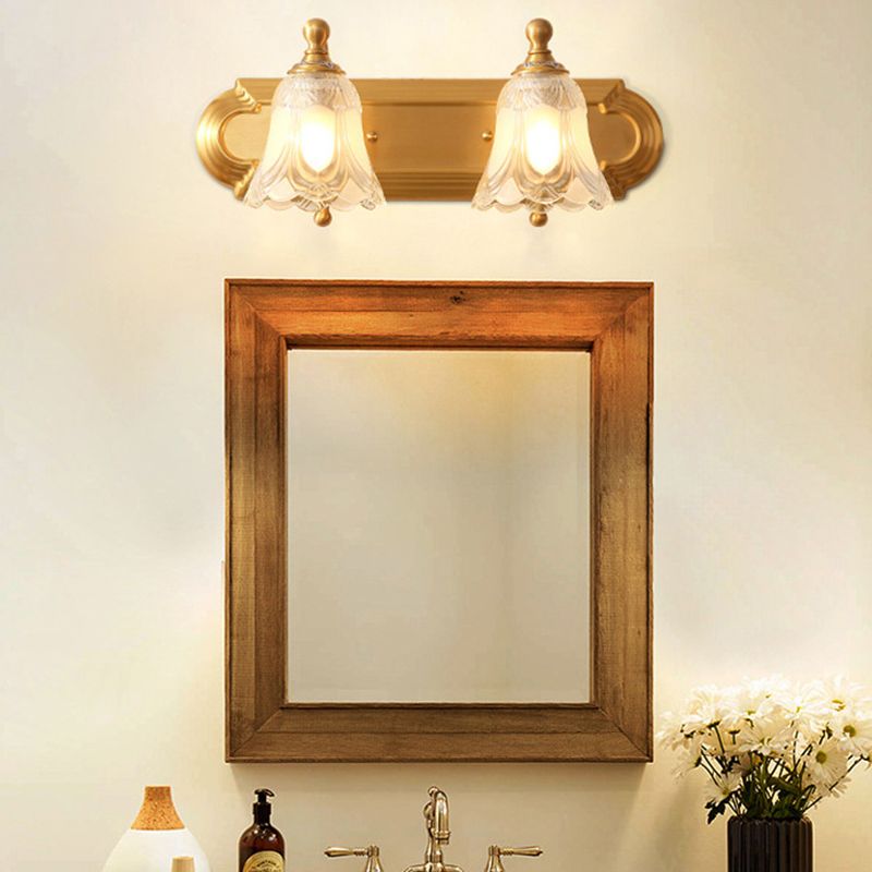 Félicie two-light wall lamp above a wooden-framed mirror
