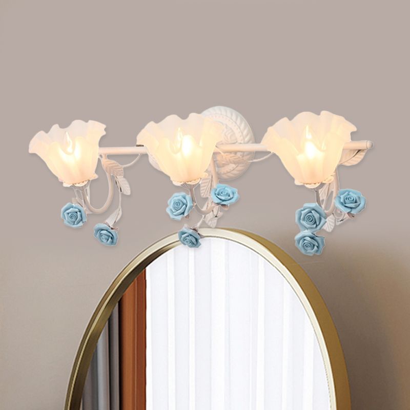 Félicie three-light blue rose fixture above an oval mirror