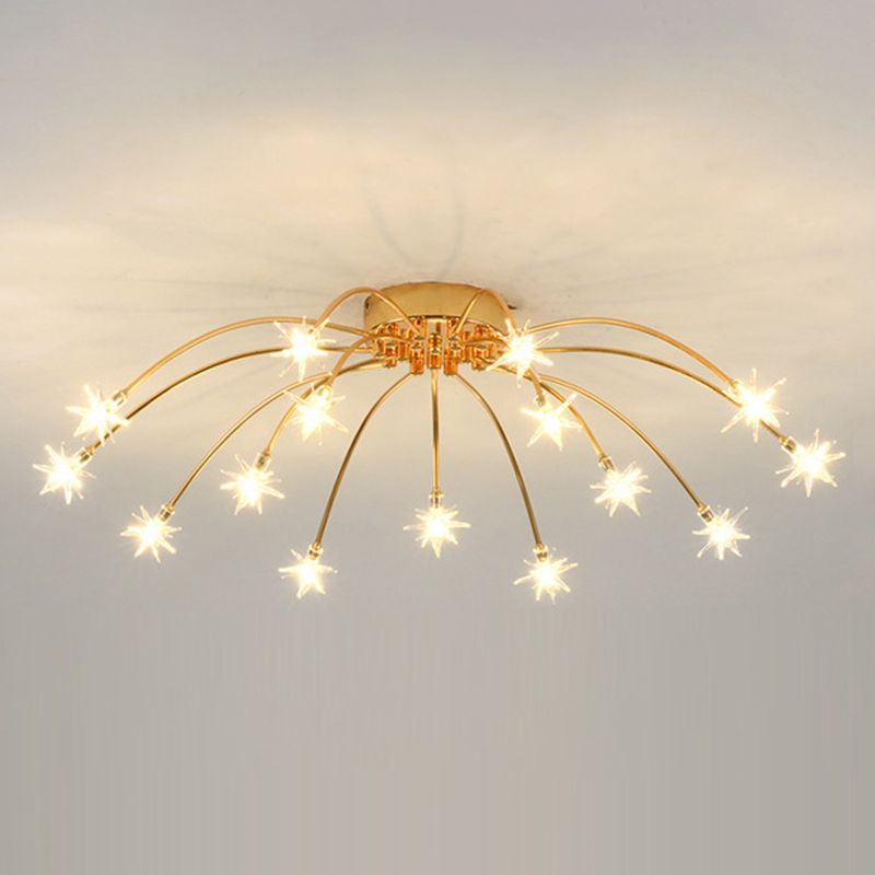 15-light Gold reference with curved metal arms, round canopy and warm-looking clear glass stars on pale ceiling