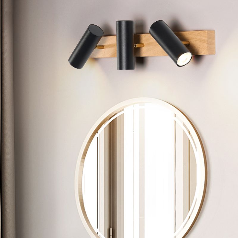 Three black heads with angled outer cylinders above a large round gold-rimmed mirror
