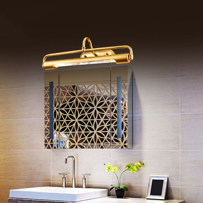 Angled view of Eryn brass-tone wall light above a mirrored cabinet and white basin