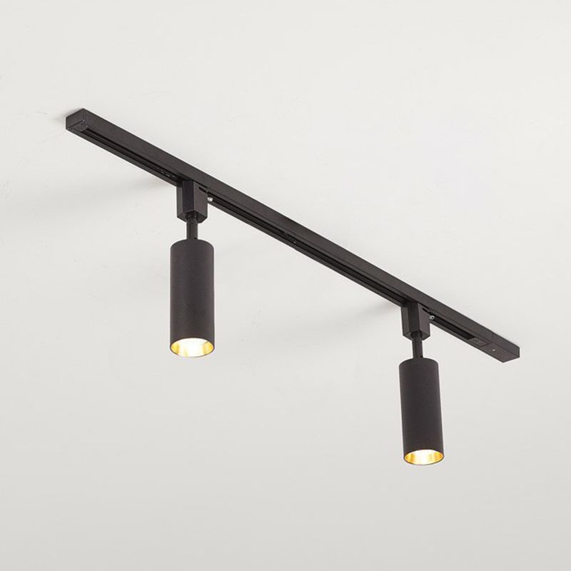 Large black two-head ceiling spotlight with longer cylinders on a black rail