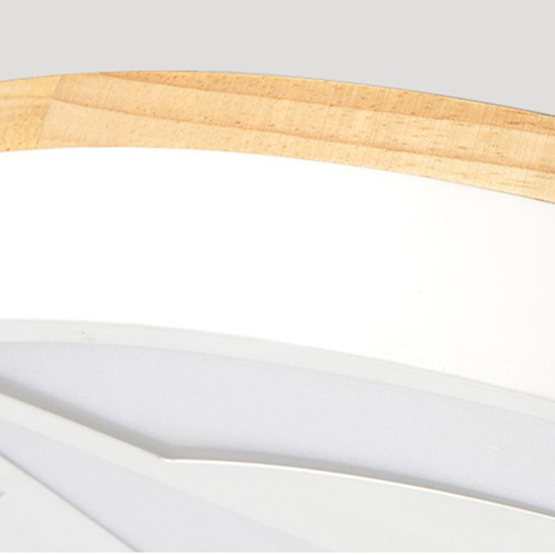 Close-up of wood-tone grain, white ceiling-light rim and the edge of the star-pattern panel