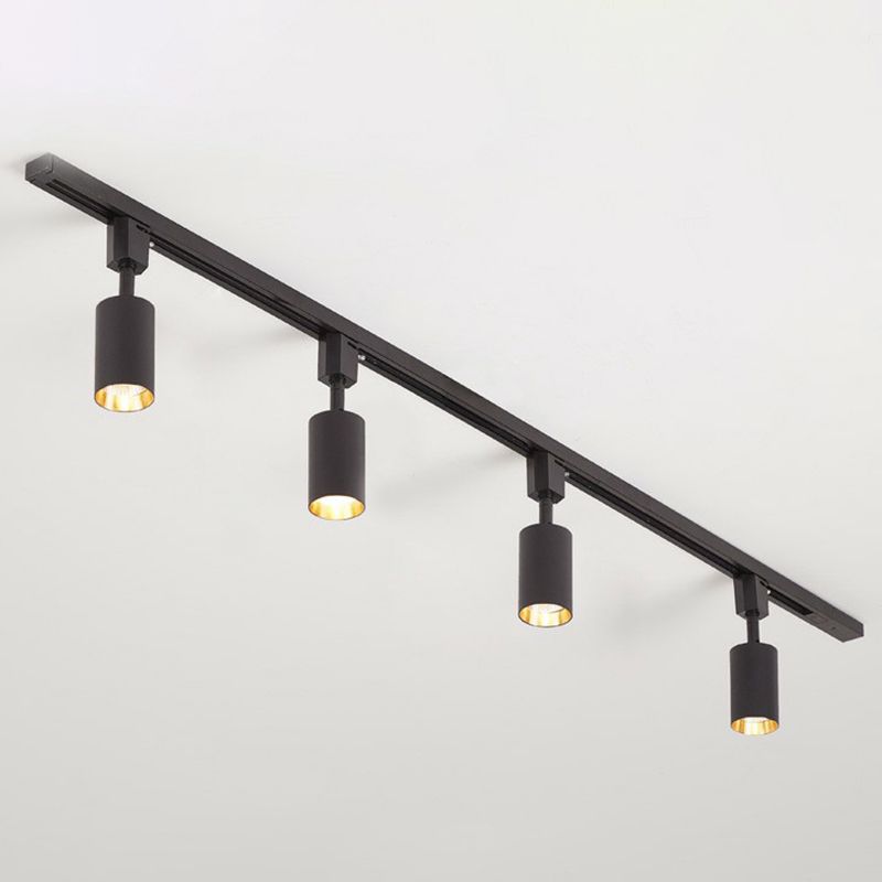 Small black four-head ceiling spotlight with short cylinders and gold-tone interiors