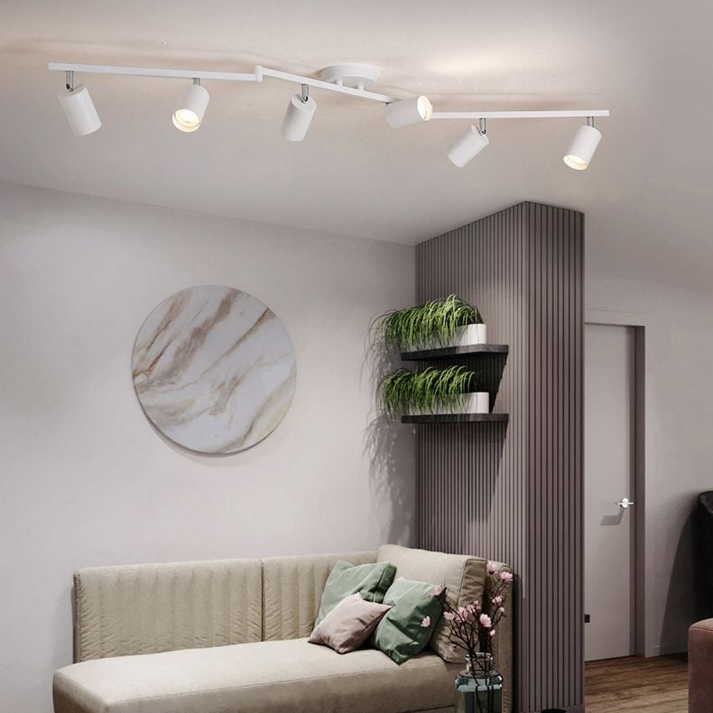 White Freja spotlight with six visible heads above a sofa with green cushions