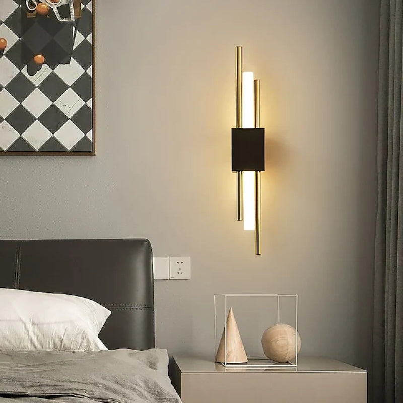 Black-and-gold Alana wall light beside a bed