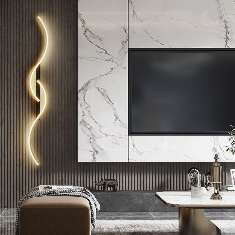 Gold-edged wave light beside a marble-pattern television surround above a brown ottoman
