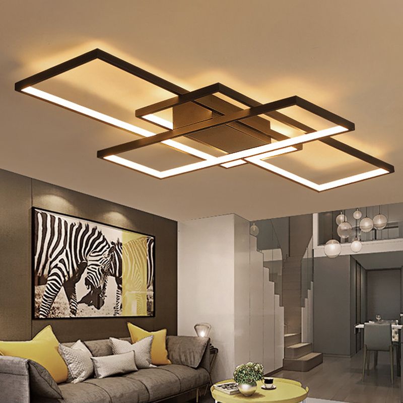 Black rectangular ceiling light with warm-looking illumination above a sofa with yellow cushions and zebra artwork