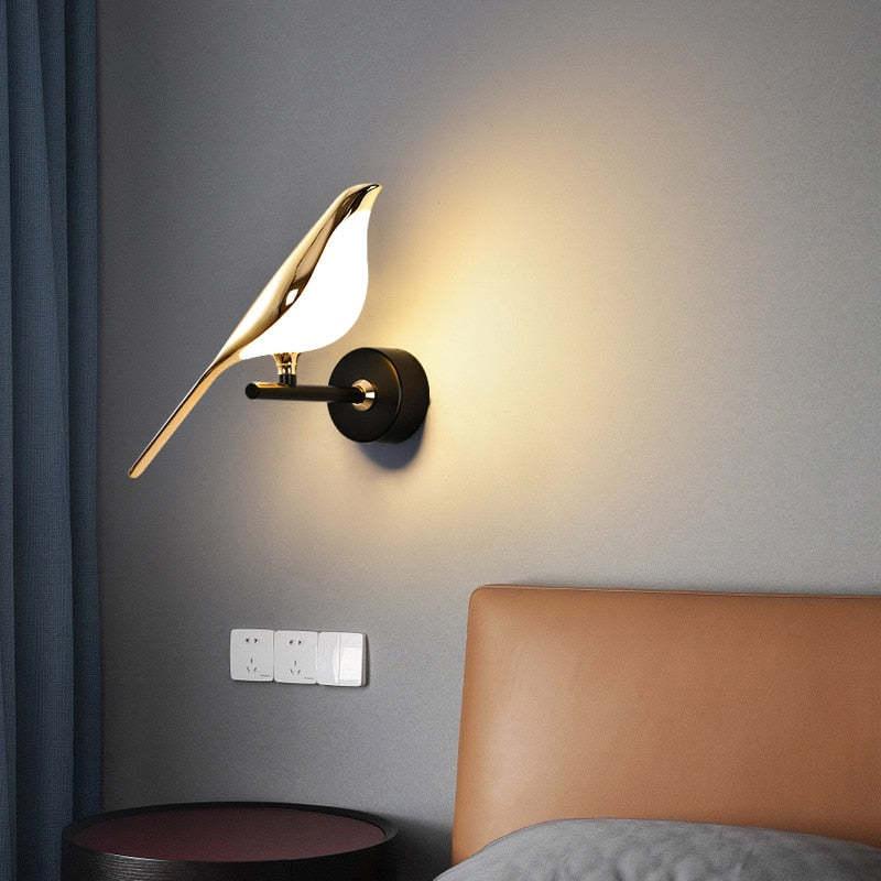 Single bird lamp near an upholstered headboard