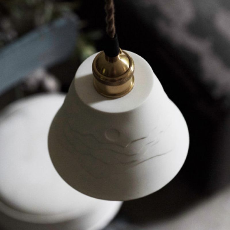 Overhead view of unlit white Lottie relief cone, metal holder and twisted cord