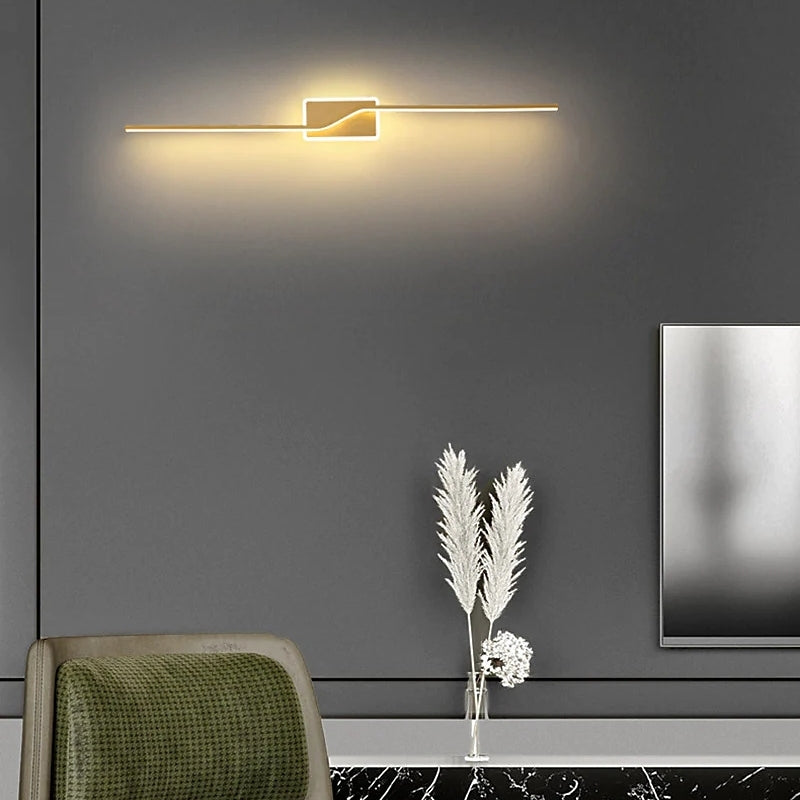 Gold-tone Nordic light bar arranged horizontally on a wall
