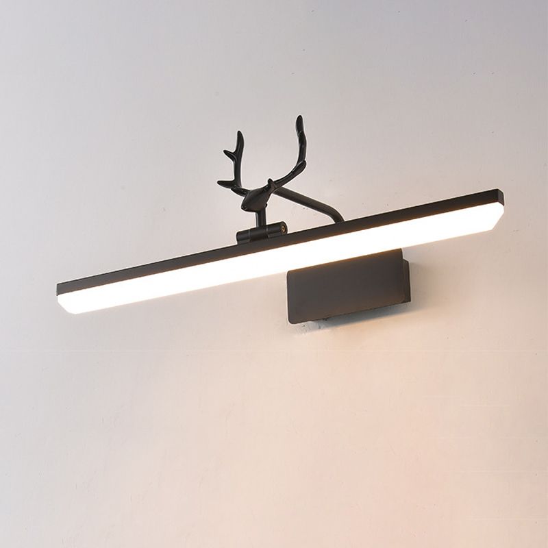 Black antler wall light viewed at an angle against a pale wall, with a lit straight diffuser and dark mounting plate