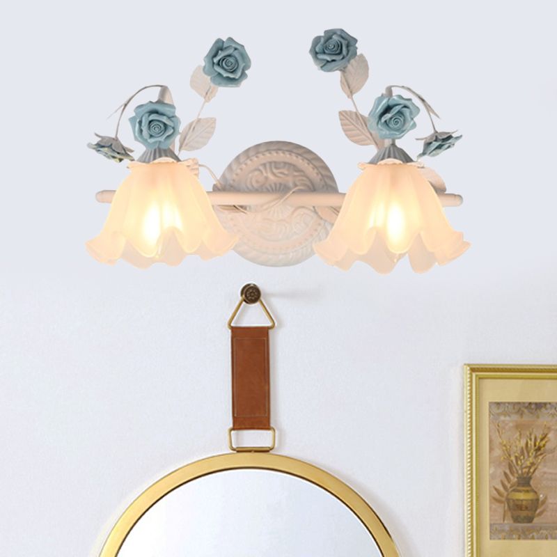 Félicie 2-Light Blue option above a round mirror