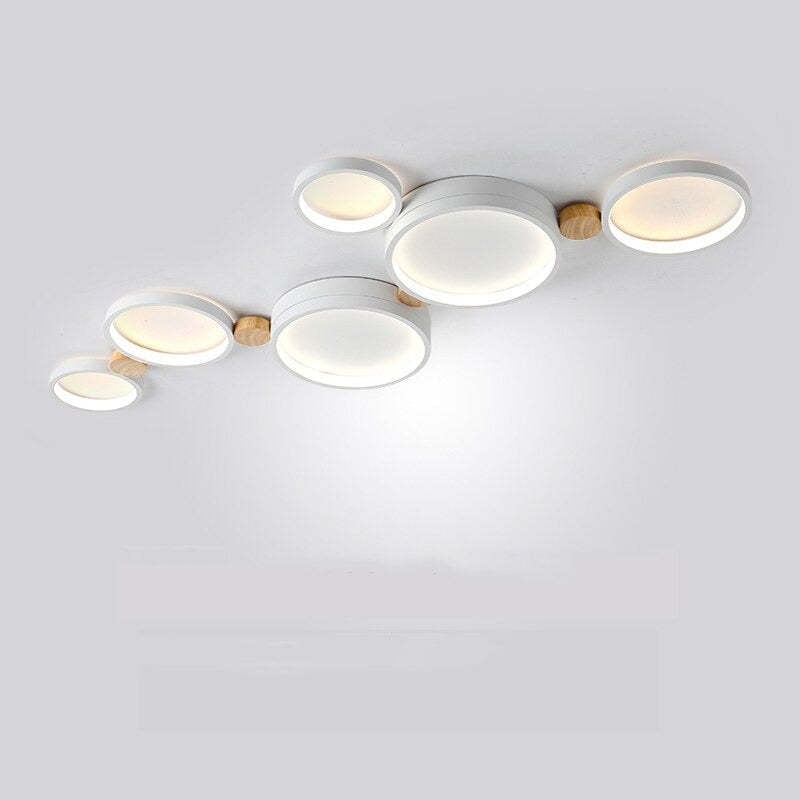 White six-head ceiling light with an extended arrangement of large and small round panels