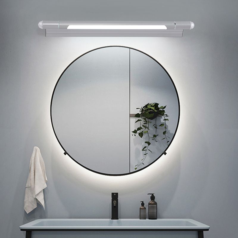 Edge silver linear fixture above a round bathroom mirror