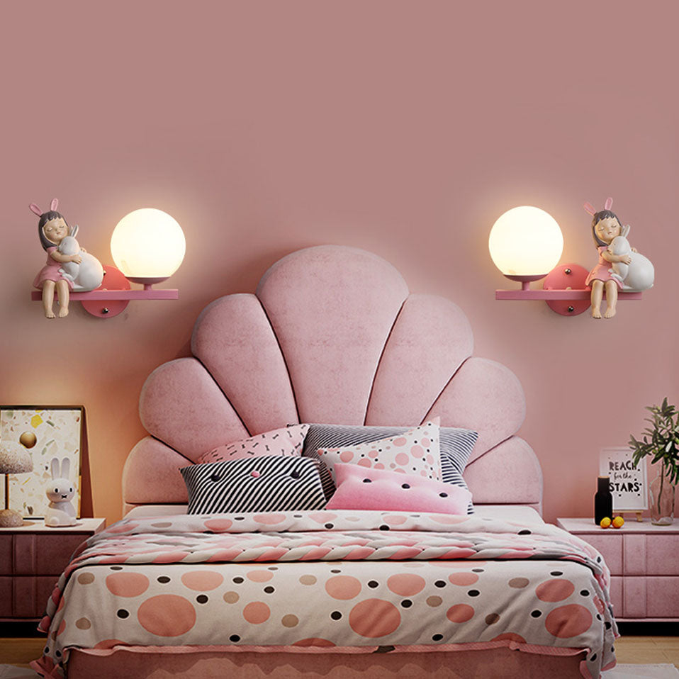Two Minori wall lights shown beside a pink upholstered bed