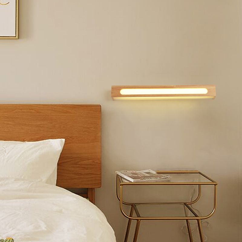 Ozawa illuminated oblong wood-bar wall light beside a wooden bedhead and bedside table
