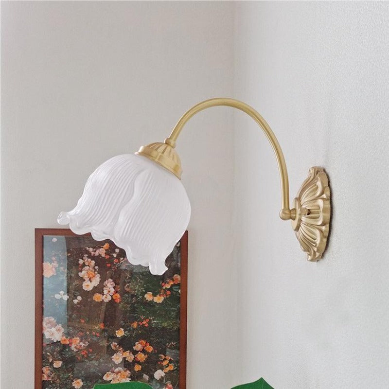 Bella pale fine-ribbed glass bell shade on a gold-colour curved arm