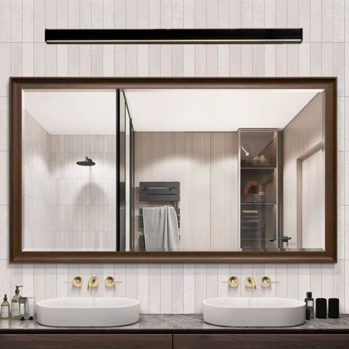 Horizontal Edge black bar wall light above a large framed bathroom mirror and two basins