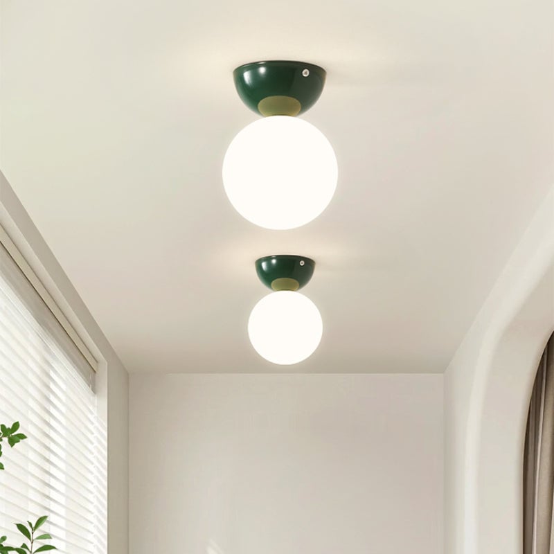 Two green Valentina globe ceiling lights in a hallway
