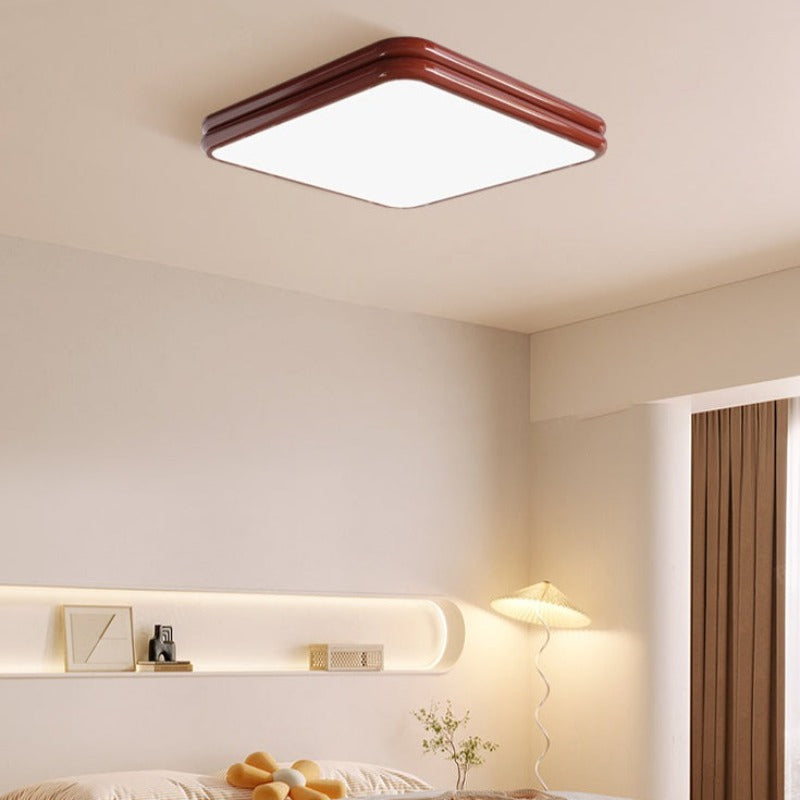 Red square Valentina ceiling light above a bed