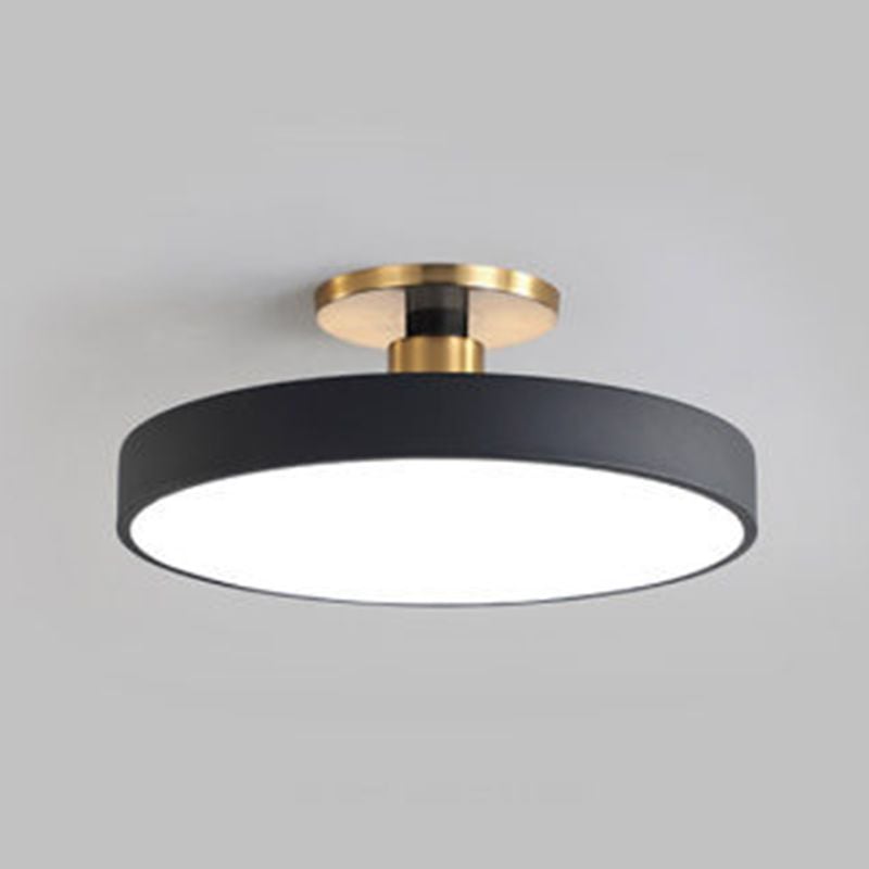 Close black circular rim and white diffuser beneath gold-tone ceiling fittings