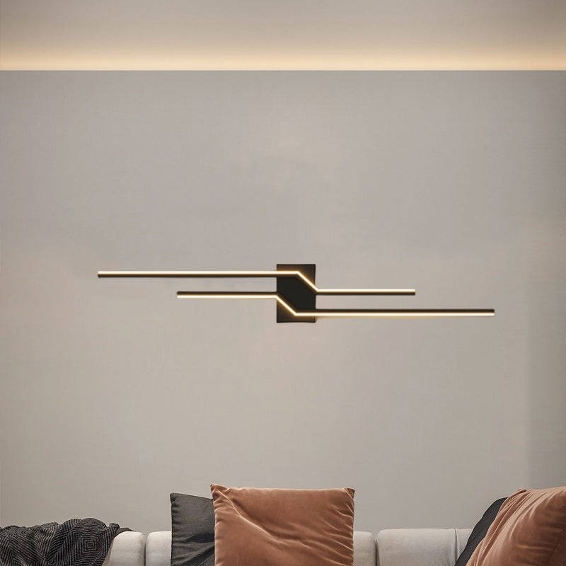 Black Alana wall light with two offset lines above a sofa