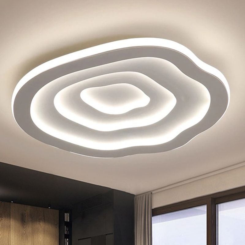 Bright white Quinn Ripple ceiling light near a window