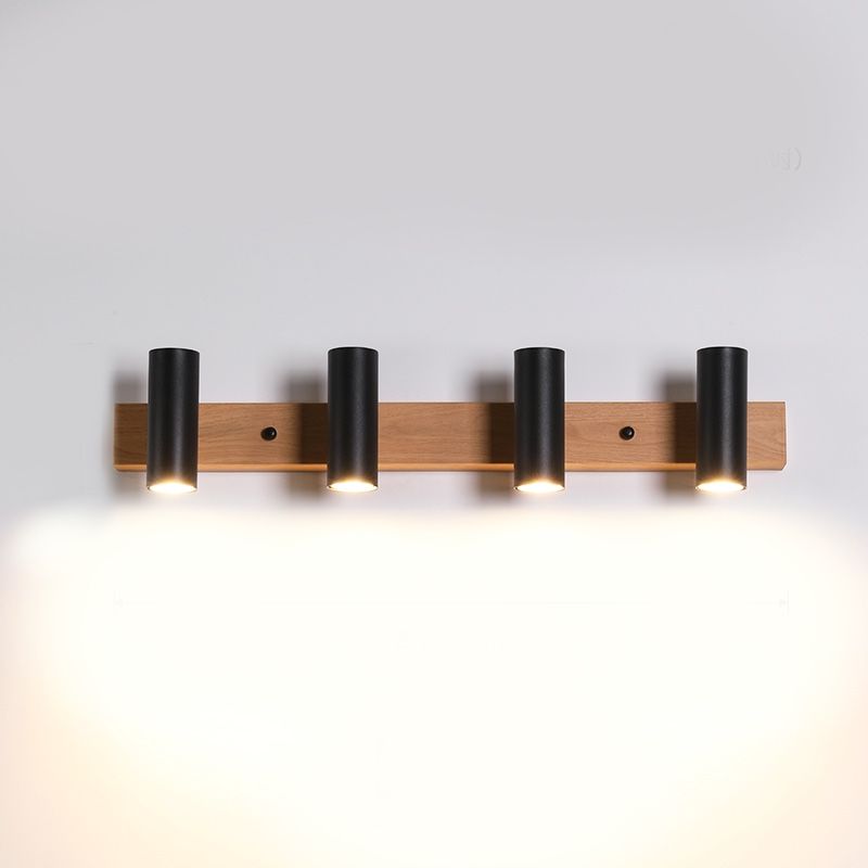 Four black cylindrical Ozawa spots facing down on a wood-grain bar in an isolated view