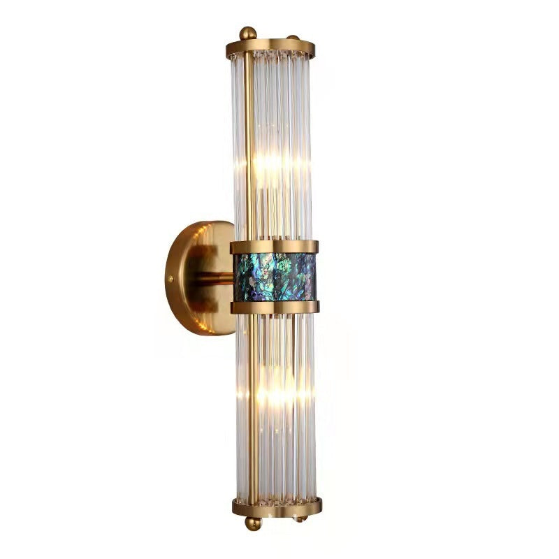 Close oblique view of the gold-tone wall plate, illuminated clear rods and blue-green patterned center