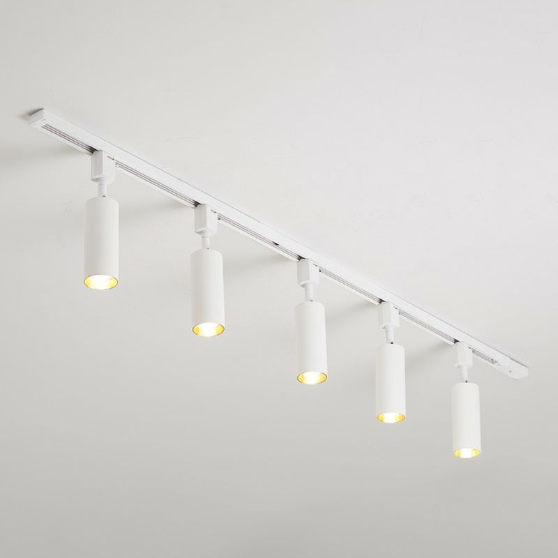 Large white five-head ceiling spotlight with longer cylinders and lit gold-tone interiors