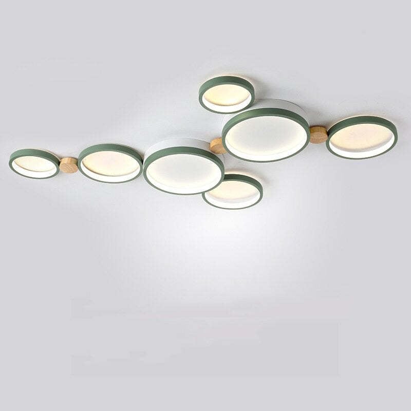 Green seven-head ceiling light with an offset disc arrangement and a branch beneath the central panel