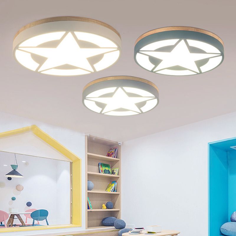 White, green and grey illuminated star-pattern ceiling lights above a colorful playroom and bookshelf